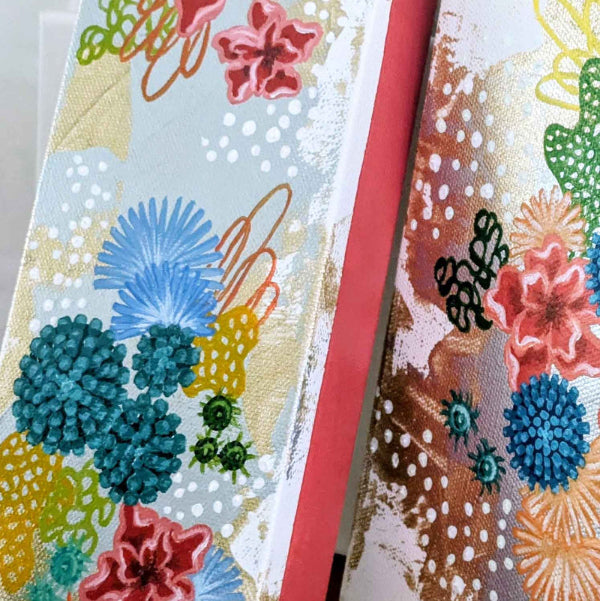 a painting with colorful coral designs on a white background