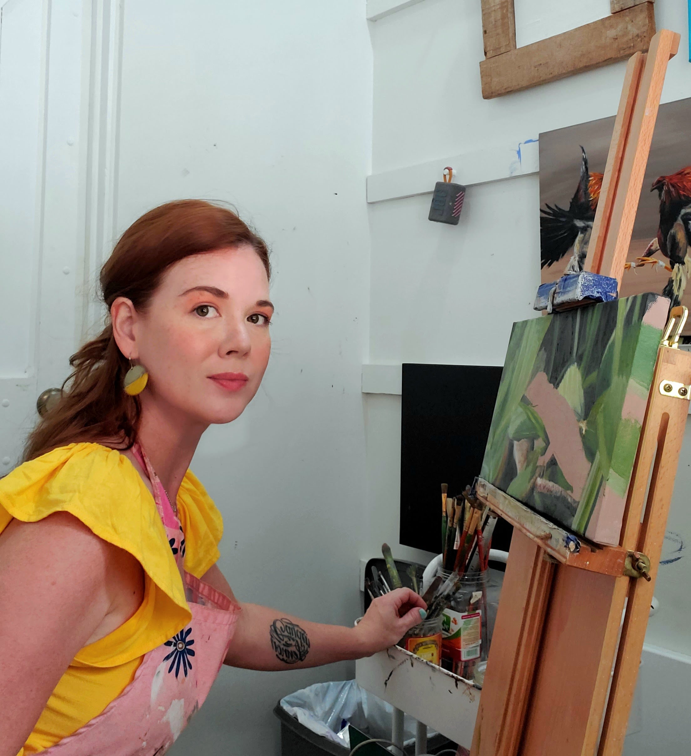 Wildlife Artist R Harvey in her art studio painting a lizard